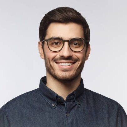 Headshot of cheerful handsome man with trendy haircut and eyeglasses isolated on gray background